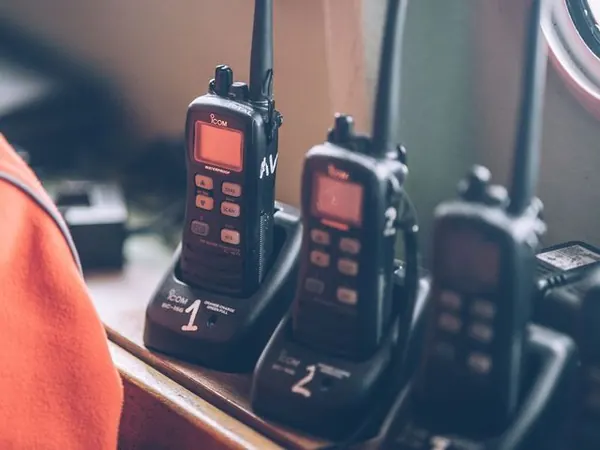 Handheld marine VHF radios in charging cradles